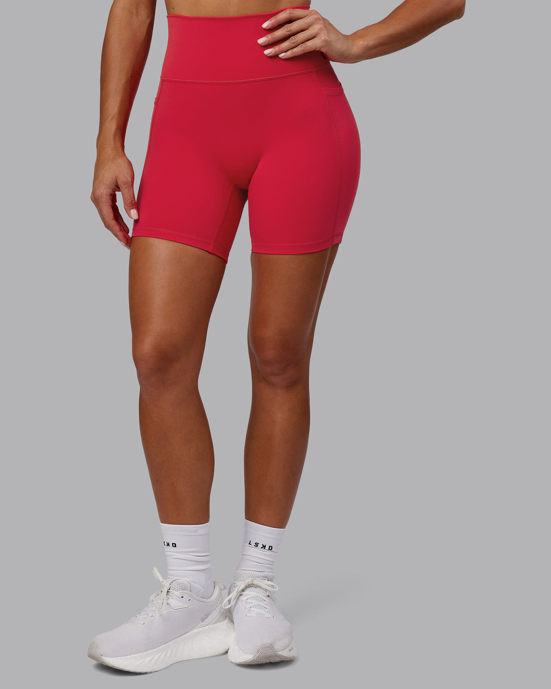 Woman wearing Fusion Ultra High-Rise 6" Short Pockets - Scarlet | Model:Demi | Size:S
