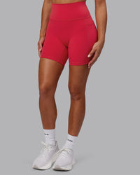 Woman wearing Fusion Ultra High-Rise 6" Short Pockets - Scarlet | Model:Demi | Size:S