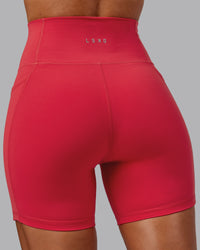 Woman wearing Fusion Ultra High-Rise 6" Short Pockets - Scarlet | Model:Demi | Size:S