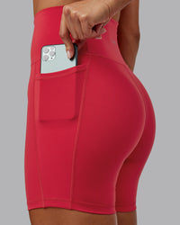 Woman wearing Fusion Ultra High-Rise 6" Short Pockets - Scarlet | Model:Demi | Size:S