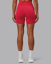 Woman wearing Fusion Ultra High-Rise 6" Short Pockets - Scarlet | Model:Demi | Size:S