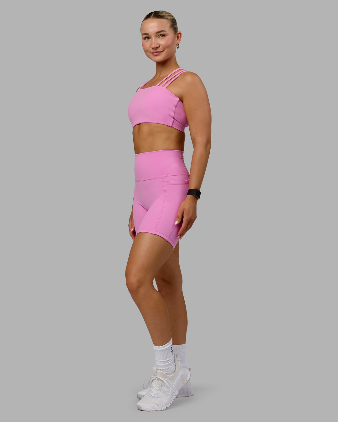 Woman wearing Fusion Ultra High-Rise 6" Short Pockets - Spark Pink | Model:Halle | Size:S