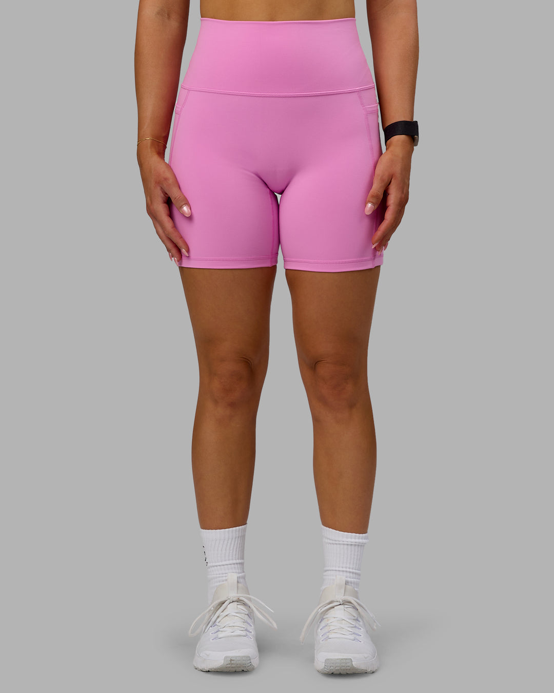 Woman wearing Fusion Ultra High-Rise 6" Short Pockets - Spark Pink | Model:Halle | Size:S