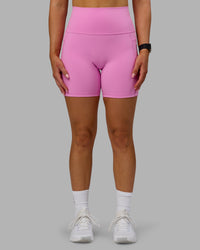 Woman wearing Fusion Ultra High-Rise 6" Short Pockets - Spark Pink | Model:Halle | Size:S