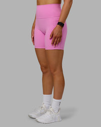 Woman wearing Fusion Ultra High-Rise 6" Short Pockets - Spark Pink | Model:Halle | Size:S