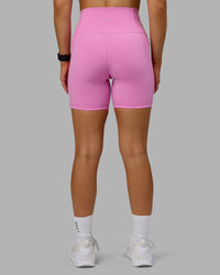 Woman wearing Fusion Ultra High-Rise 6" Short Pockets - Spark Pink | Model:Halle | Size:S
