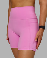 Woman wearing Fusion Ultra High-Rise 6" Short Pockets - Spark Pink | Model:Halle | Size:S