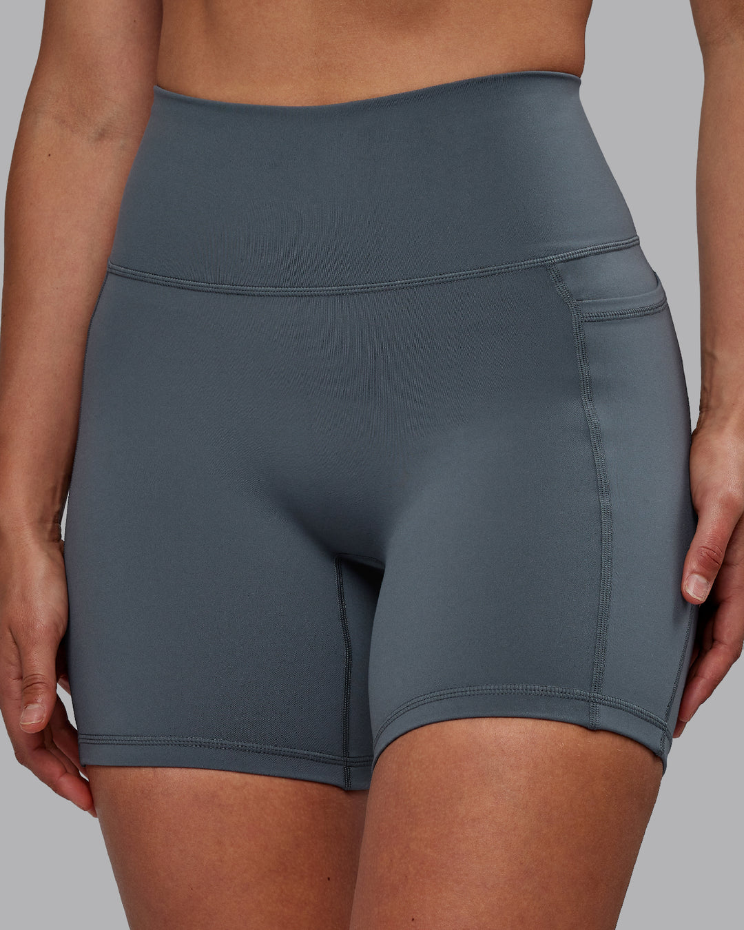 Woman wearing Fusion Ultra High-Rise 6&quot; Short Pockets - Turbulence | Model:Sophie | Size:S