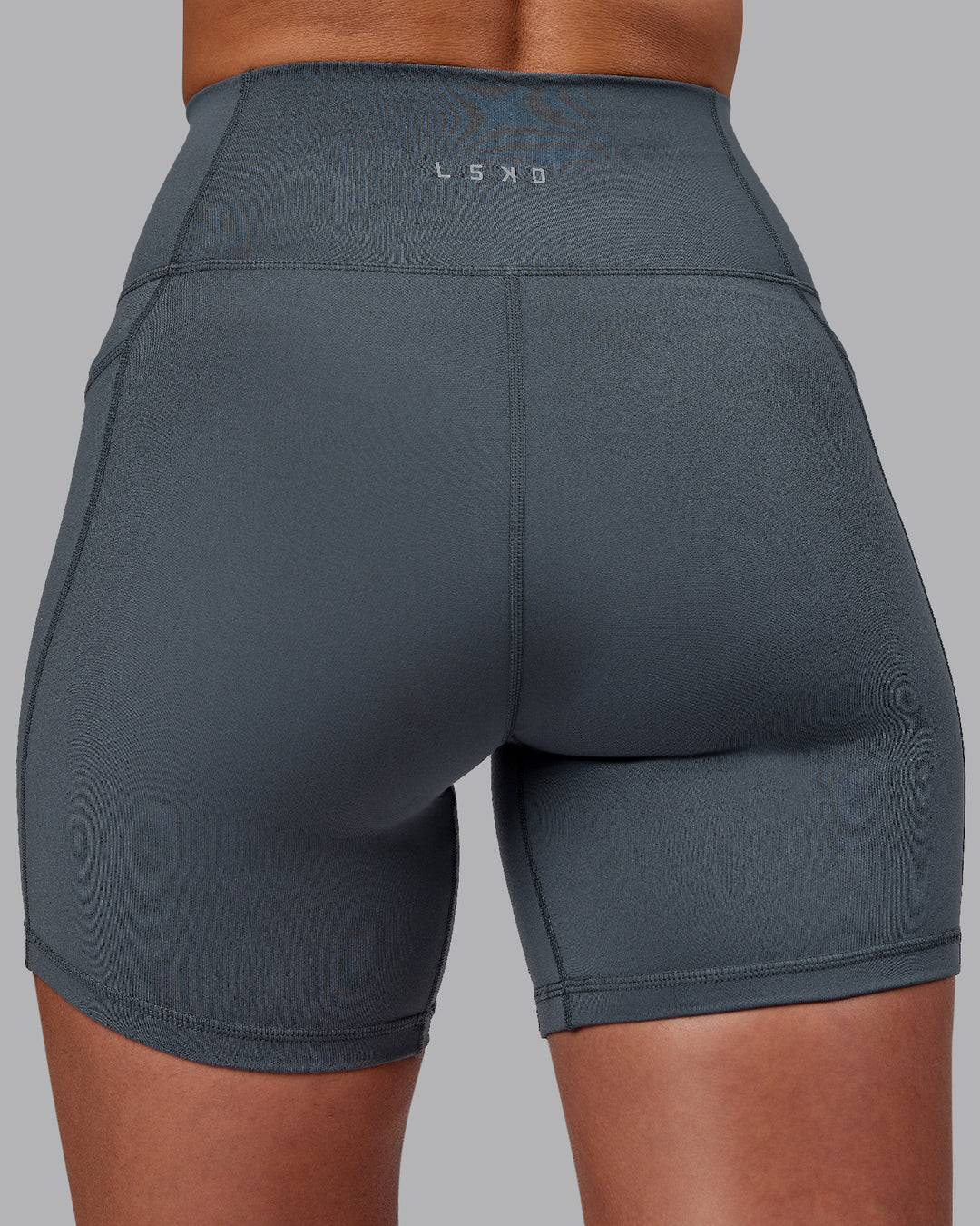 Woman wearing Fusion Ultra High-Rise 6&quot; Short Pockets - Turbulence | Model:Sophie | Size:S