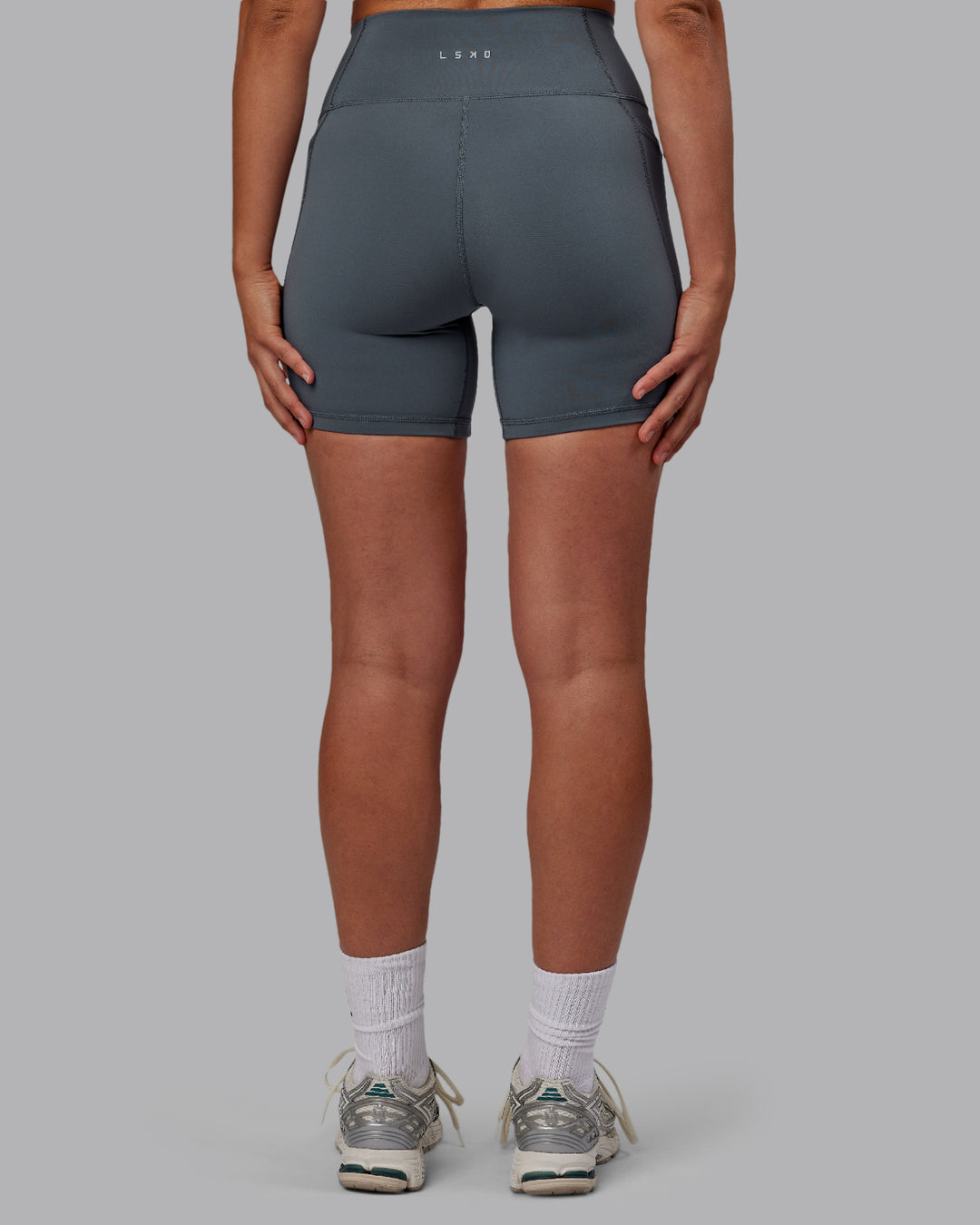 Woman wearing Fusion Ultra High-Rise 6&quot; Short Pockets - Turbulence | Model:Sophie | Size:S