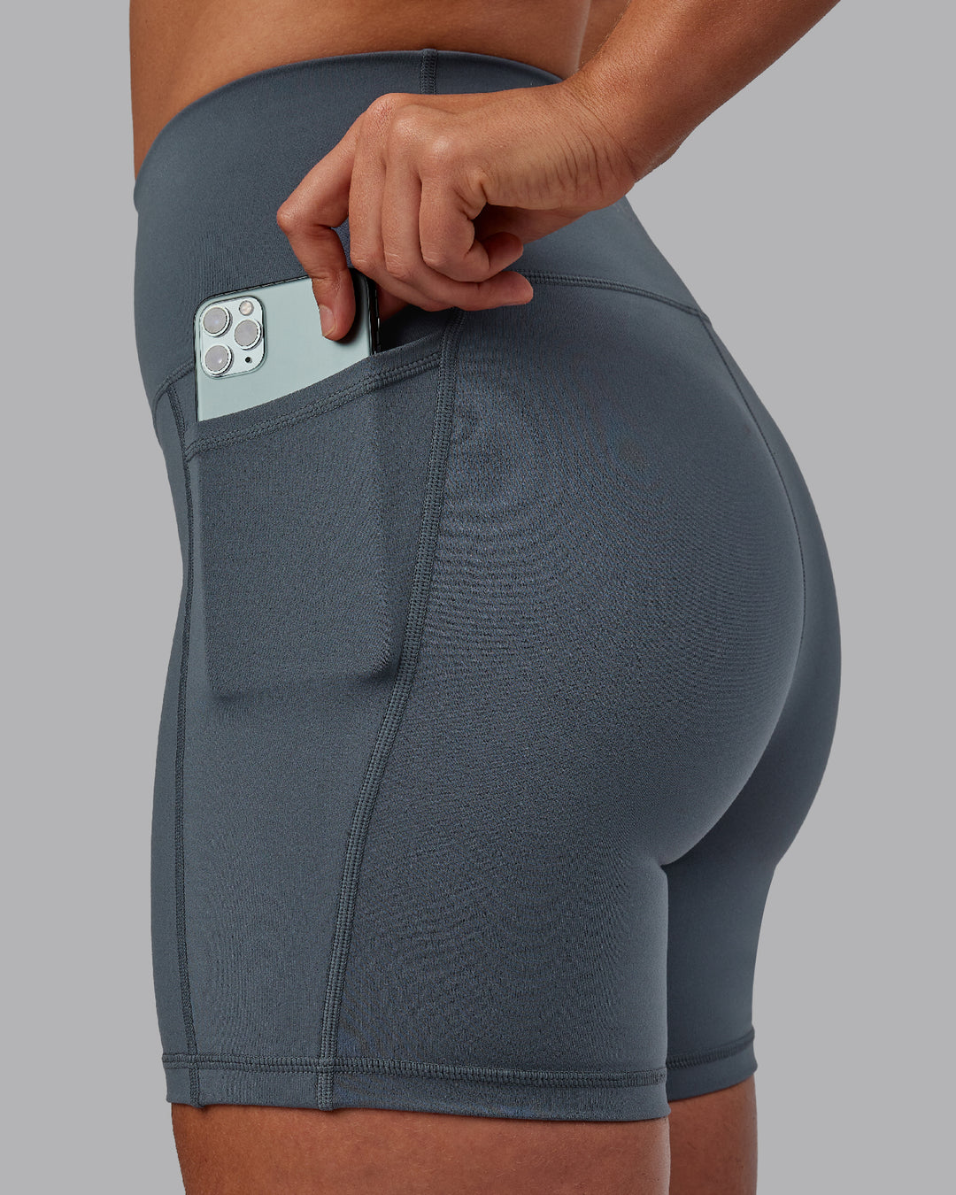 Woman wearing Fusion Ultra High-Rise 6&quot; Short Pockets - Turbulence | Model:Sophie | Size:S