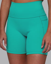 Woman wearing Fusion Ultra High-Rise 6" Short Pockets - Turquoise Tide | Model:Hannah | Size:S