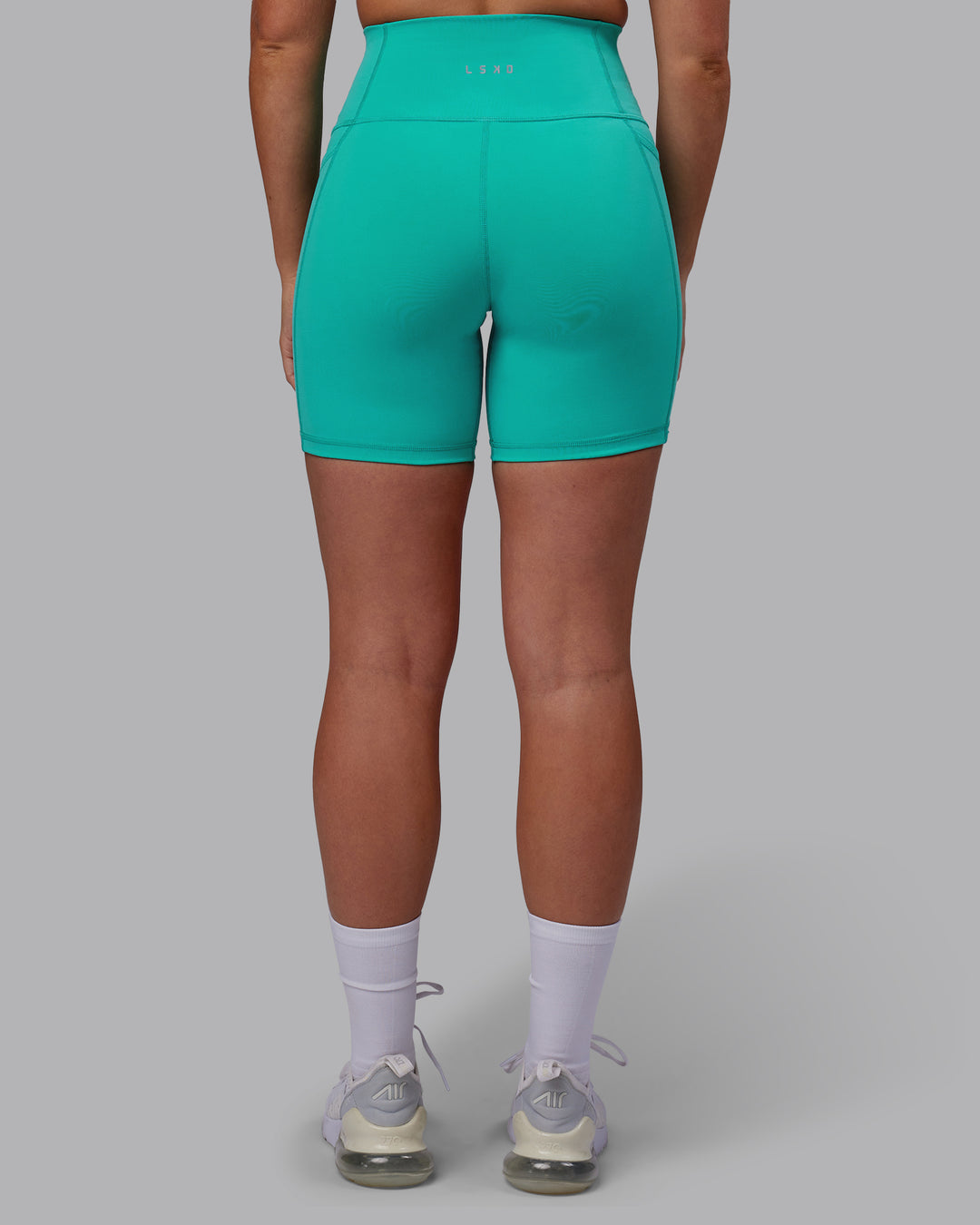 Woman wearing Fusion Ultra High-Rise 6" Short Pockets - Turquoise Tide | Model:Hannah | Size:S