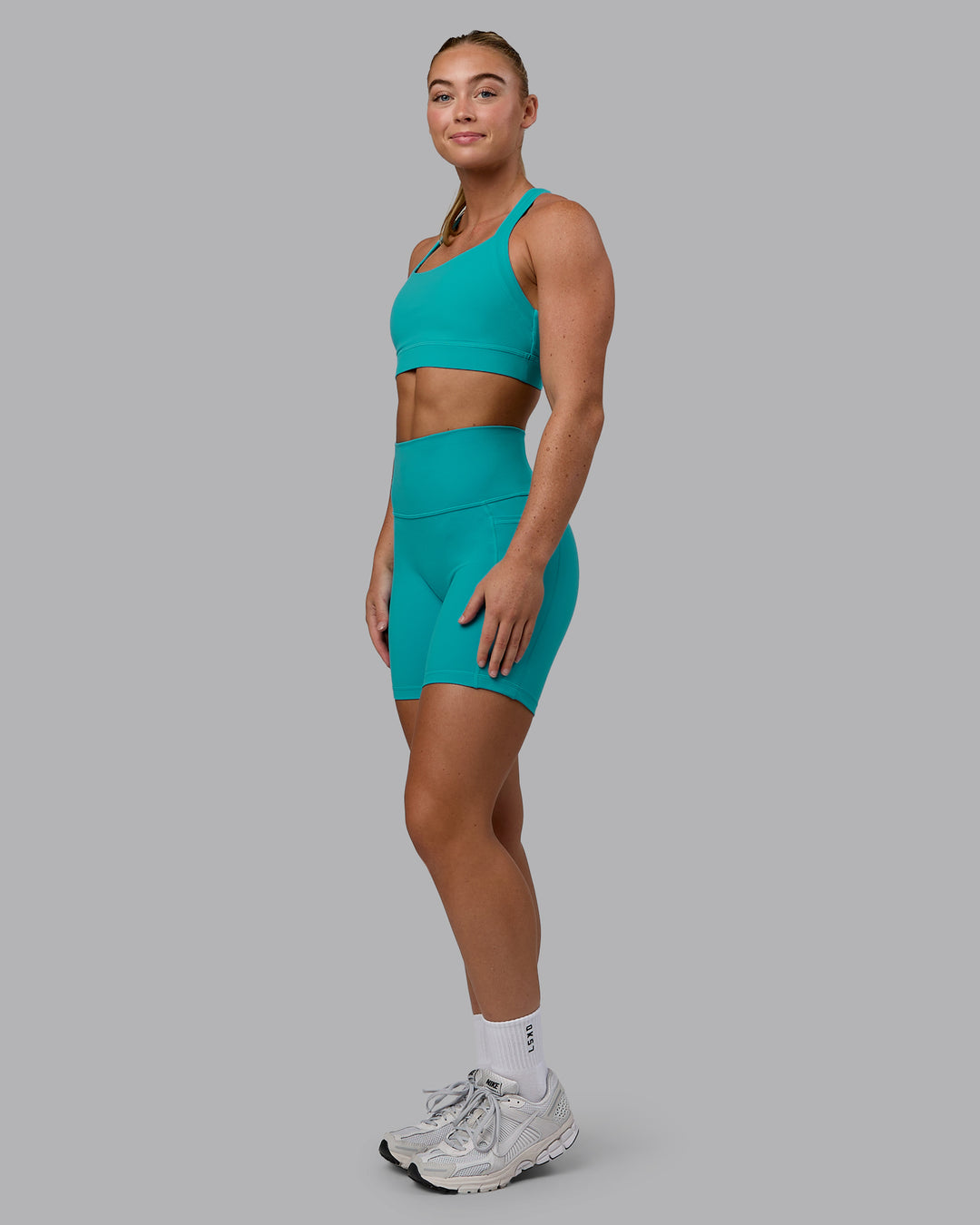 Woman wearing Fusion Ultra High-Rise 6" Short Pockets - Uplift Blue | Model:Monique | Size:S