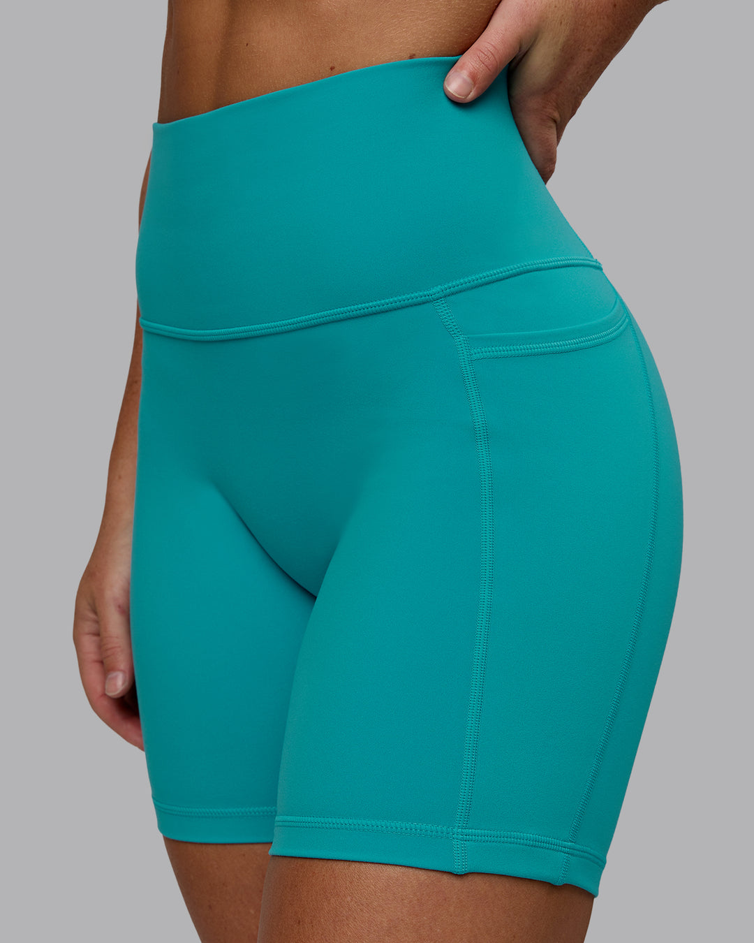 Woman wearing Fusion Ultra High-Rise 6" Short Pockets - Uplift Blue | Model:Monique | Size:S