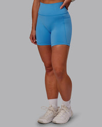 Woman wearing Fusion Ultra High-Rise 6" Short Pockets - Azure Blue | Model:Amber | Size:S