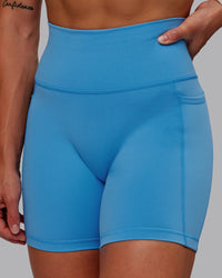 Woman wearing Fusion Ultra High-Rise 6" Short Pockets - Azure Blue | Model:Amber | Size:S