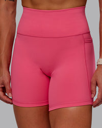 Woman wearing Fusion Ultra High-Rise 6" Short Pockets - Hot Pink | Model:Amber | Size:S