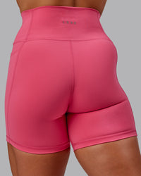 Woman wearing Fusion Ultra High-Rise 6" Short Pockets - Hot Pink | Model:Amber | Size:S