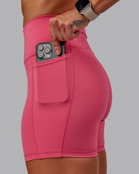 Woman wearing Fusion Ultra High-Rise 6" Short Pockets - Hot Pink | Model:Amber | Size:S