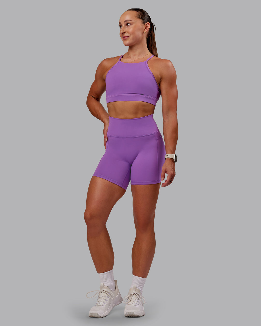 Woman wearing Fusion Ultra High-Rise 6" Short Pockets - Purple Fizz | Model:Amber | Size:S