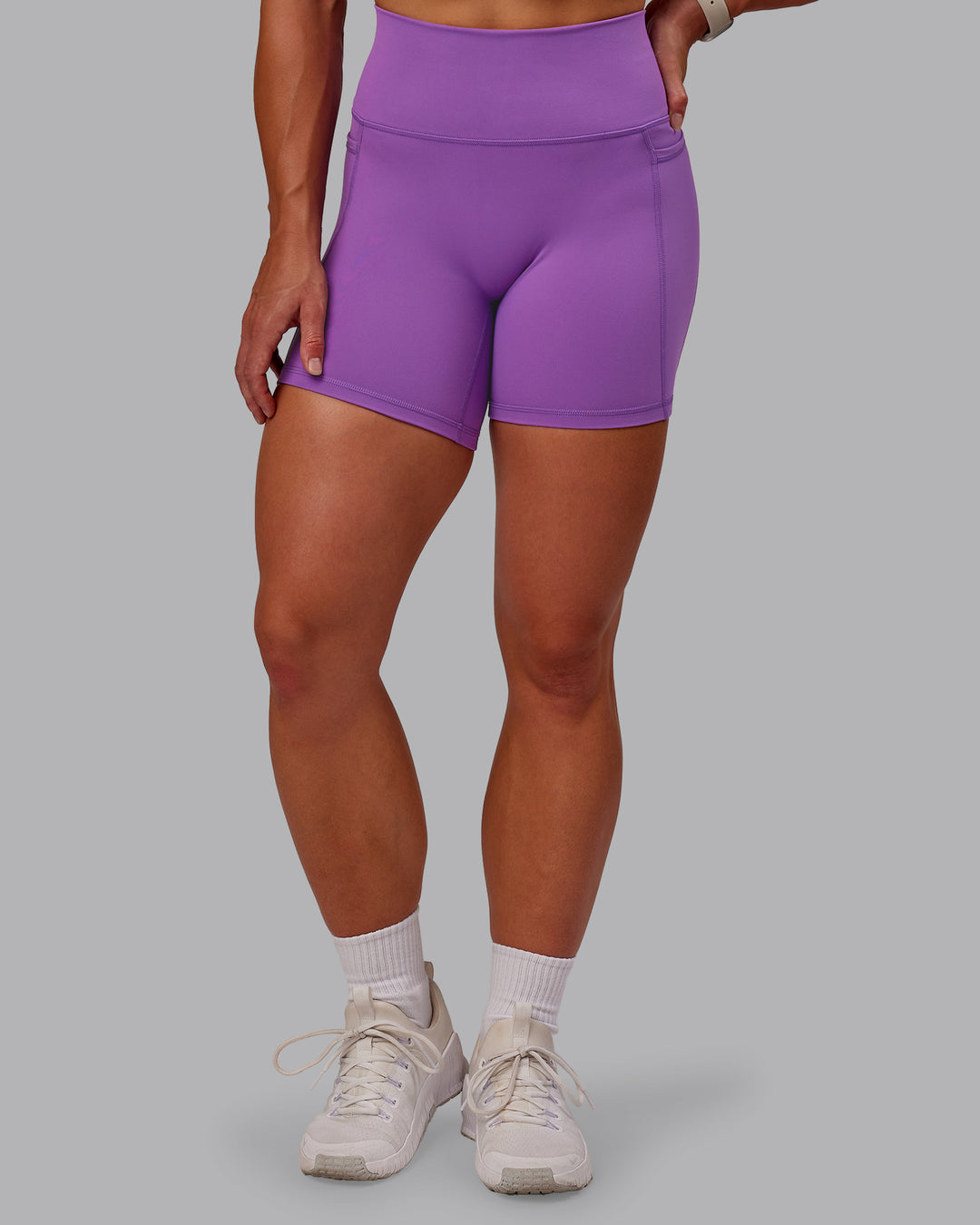 Woman wearing Fusion Ultra High-Rise 6&quot; Short Pockets - Purple Fizz | Model:Amber | Size:S