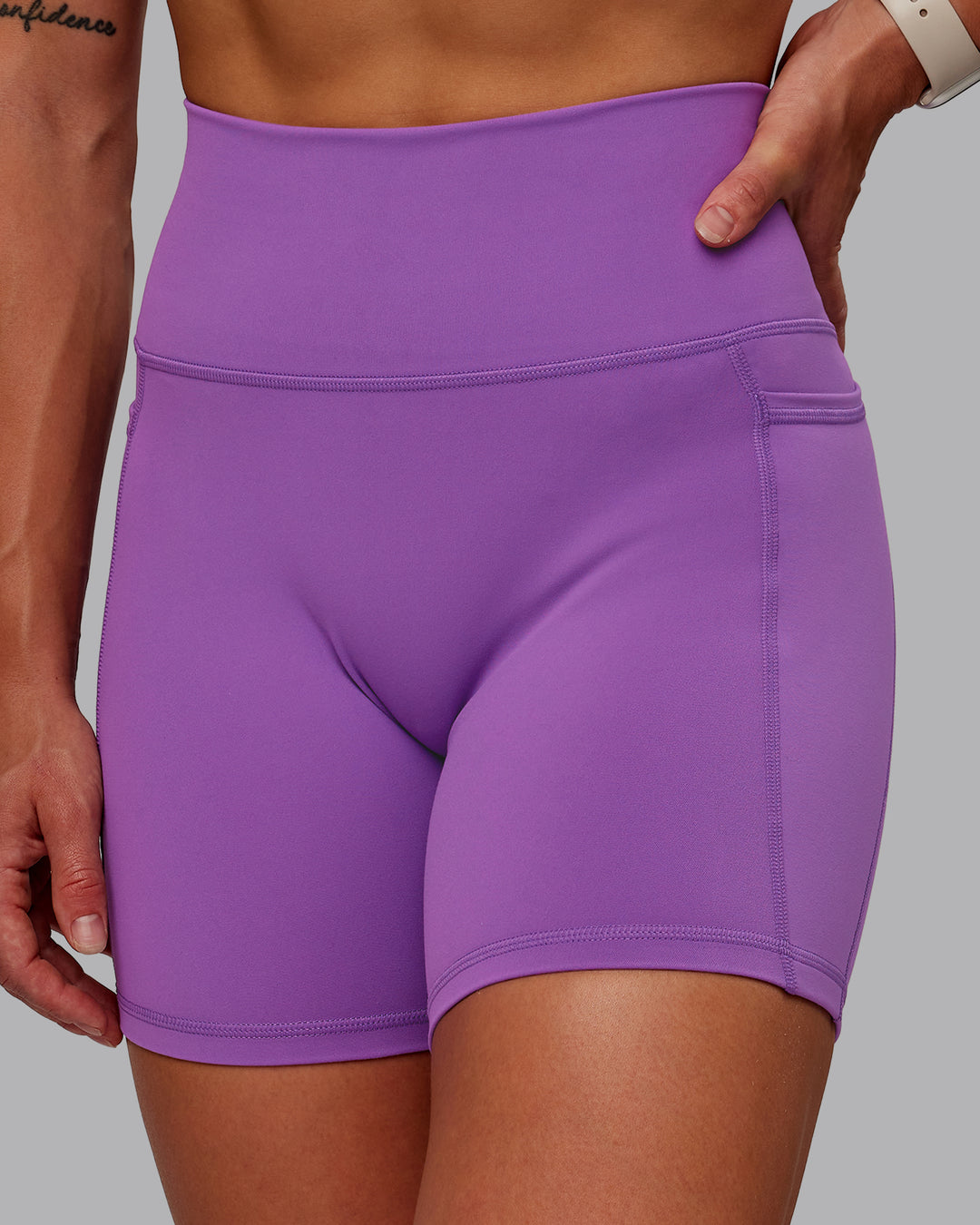 Woman wearing Fusion Ultra High-Rise 6&quot; Short Pockets - Purple Fizz | Model:Amber | Size:S