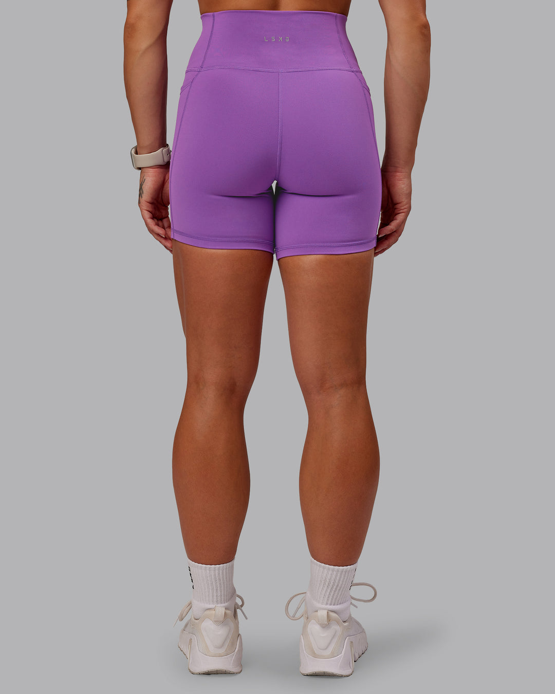 Woman wearing Fusion Ultra High-Rise 6&quot; Short Pockets - Purple Fizz | Model:Amber | Size:S