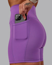 Woman wearing Fusion Ultra High-Rise 6" Short Pockets - Purple Fizz | Set:true | Angle:closeup | Model:Amber | Size:S