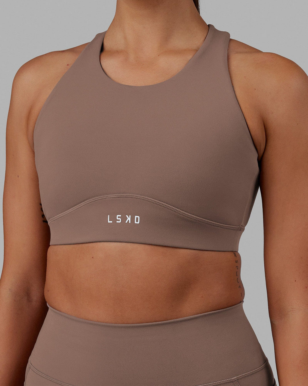 Woman wearing Fusion Sports Bra - Deep Taupe