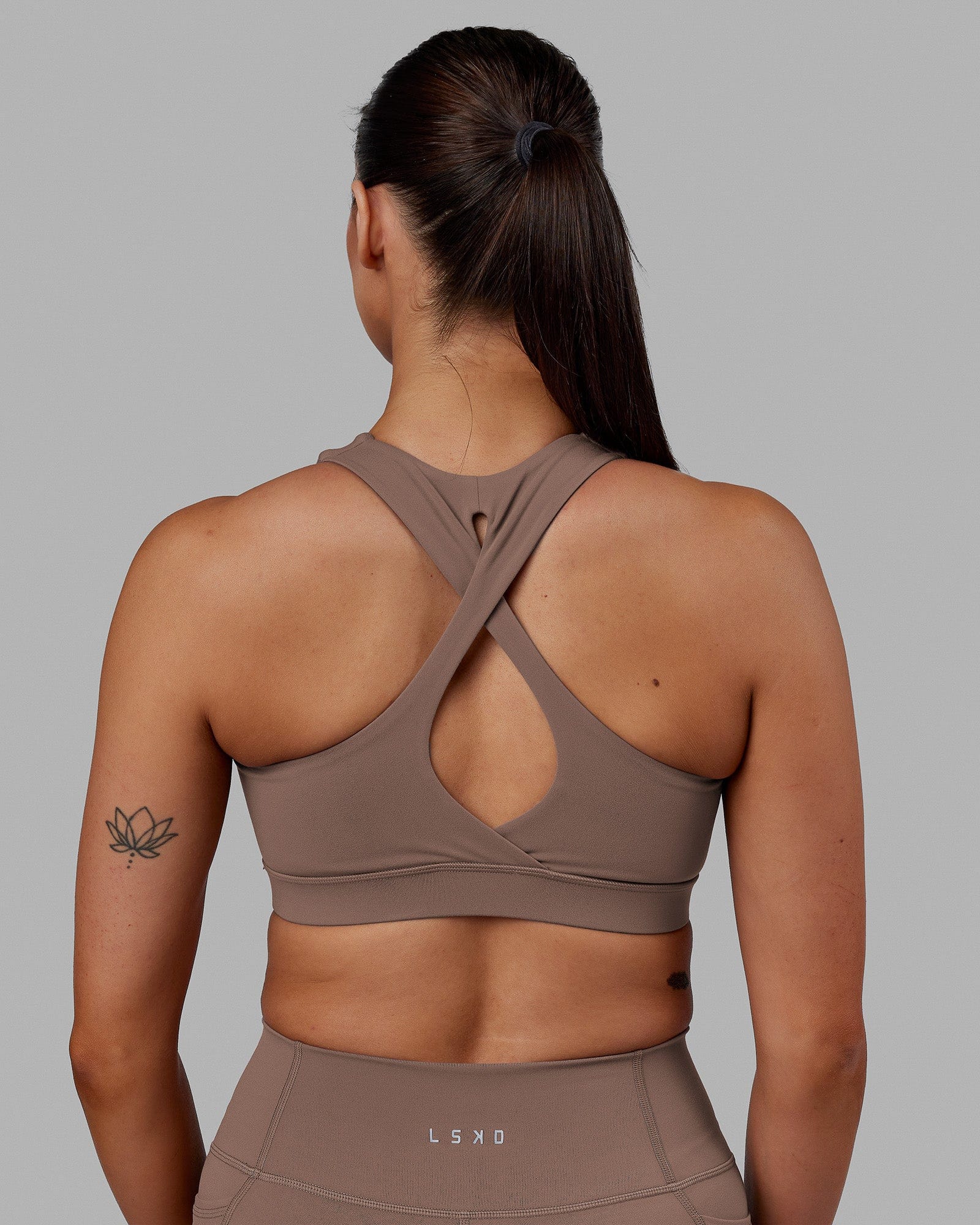 Woman wearing Fusion Sports Bra - Deep Taupe