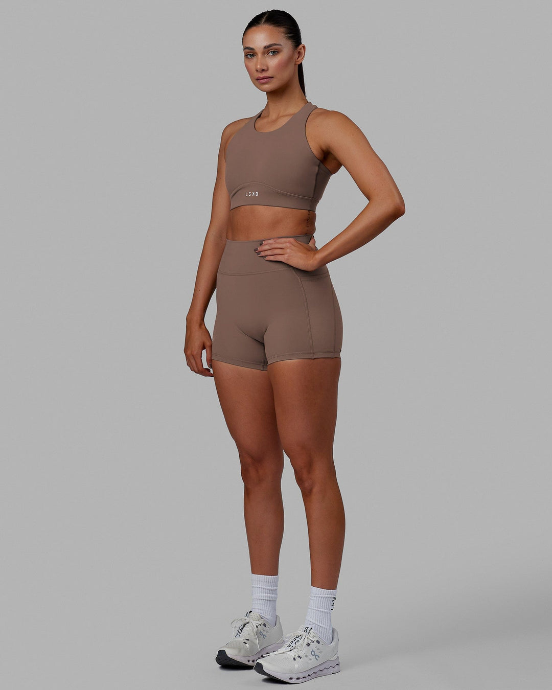 Woman wearing Fusion Sports Bra - Deep Taupe