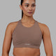 Woman wearing Fusion Sports Bra - Deep Taupe