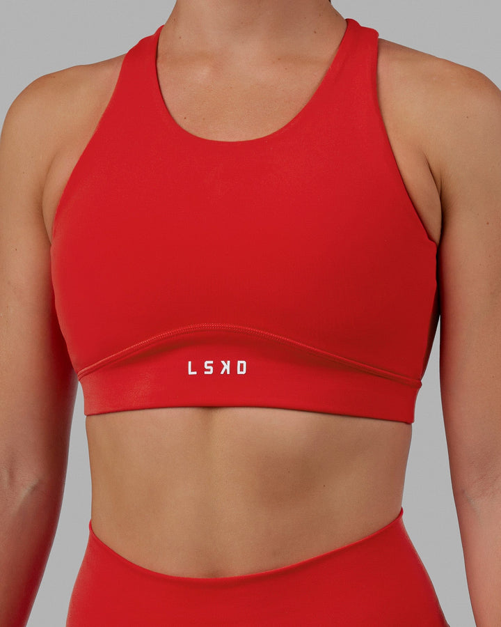 Woman wearing Fusion Sports Bra - Infrared