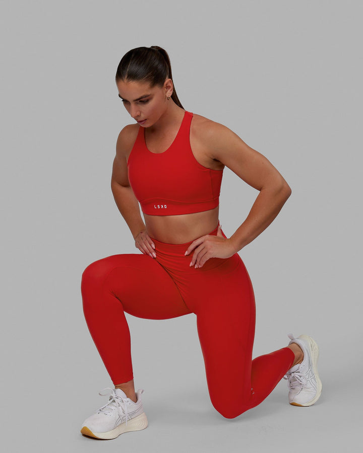 Woman wearing Fusion Sports Bra - Infrared
