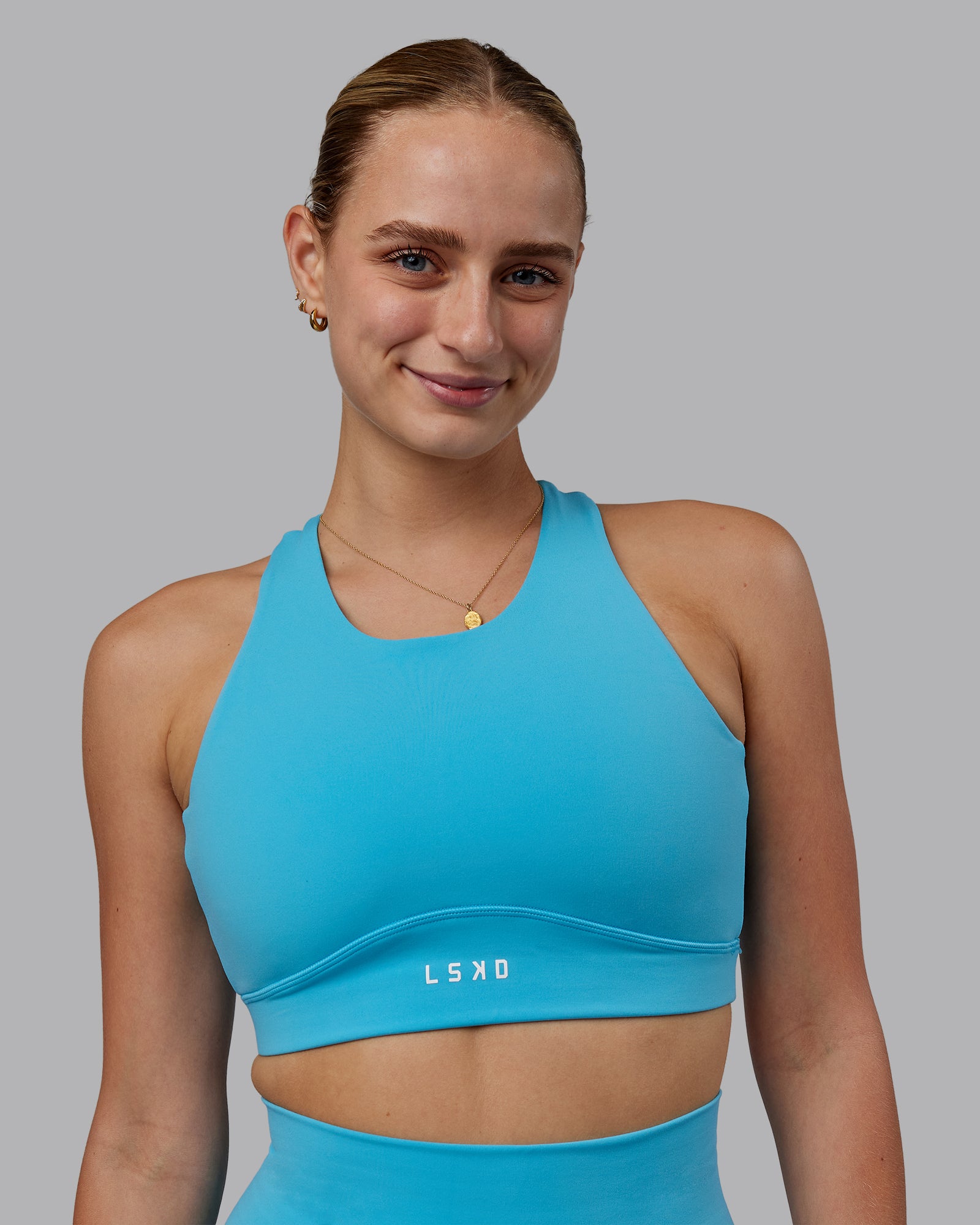Woman wearing Fusion Sports Bra - Pacific Blue