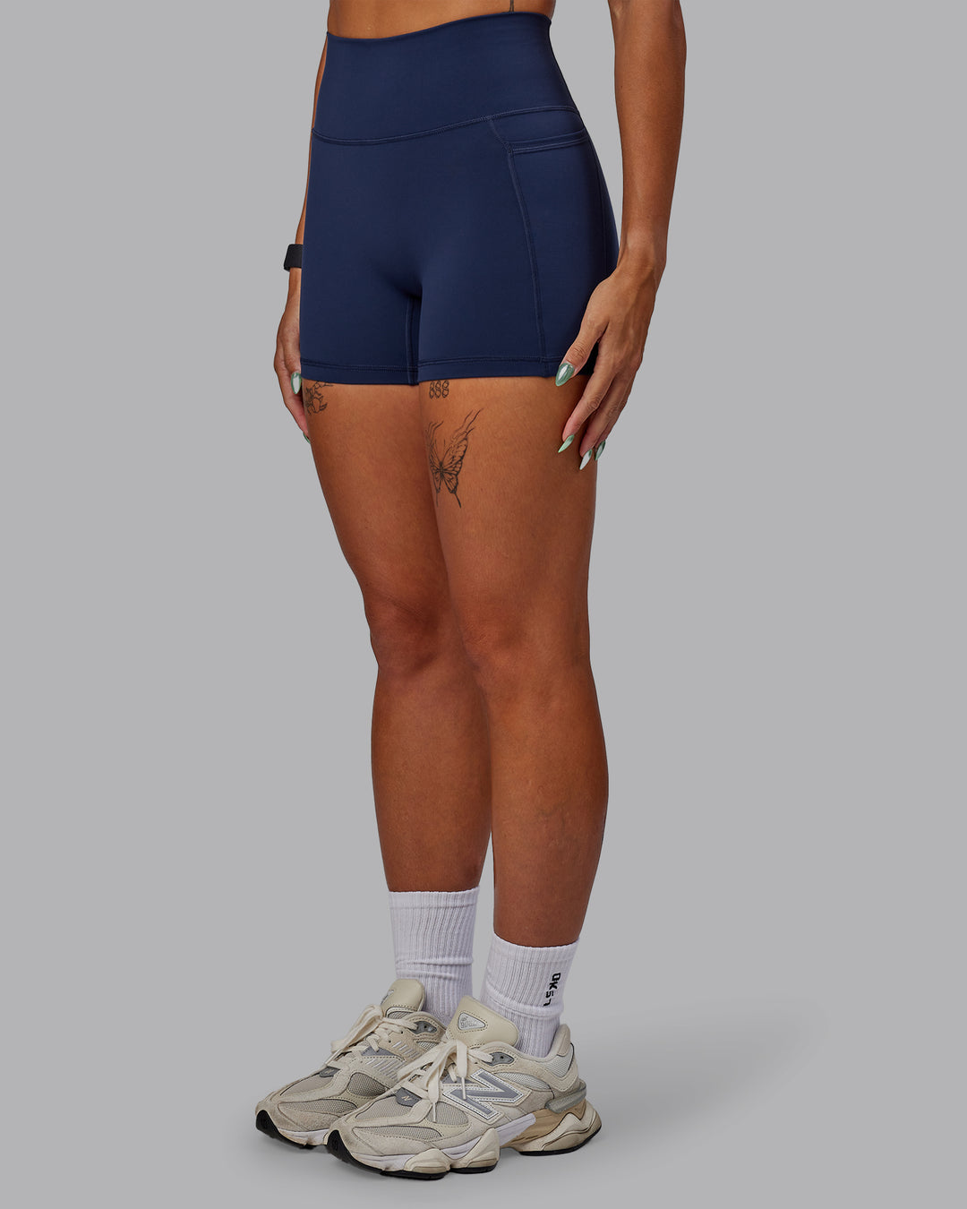 Woman wearing Fusion Ultra High-Rise 4&quot; Short Pockets - Future Navy | Model:Vanessa | Size:S