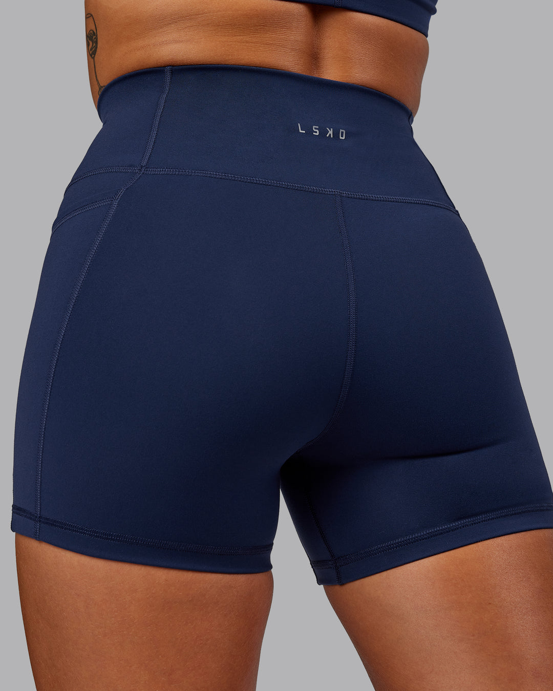 Woman wearing Fusion Ultra High-Rise 4&quot; Short Pockets - Future Navy | Model:Vanessa | Size:S