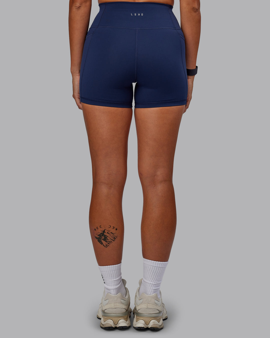 Woman wearing Fusion Ultra High-Rise 4&quot; Short Pockets - Future Navy | Model:Vanessa | Size:S