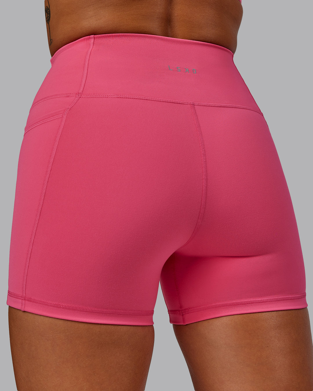Woman wearing Fusion Ultra High-Rise 4&quot; Short Pockets - Hot Pink | Model:Vanessa | Size:S