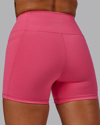 Woman wearing Fusion Ultra High-Rise 4" Short Pockets - Hot Pink | Model:Vanessa | Size:S