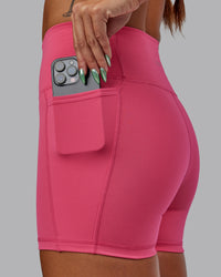 Woman wearing Fusion Ultra High-Rise 4" Short Pockets - Hot Pink | Model:Vanessa | Size:S