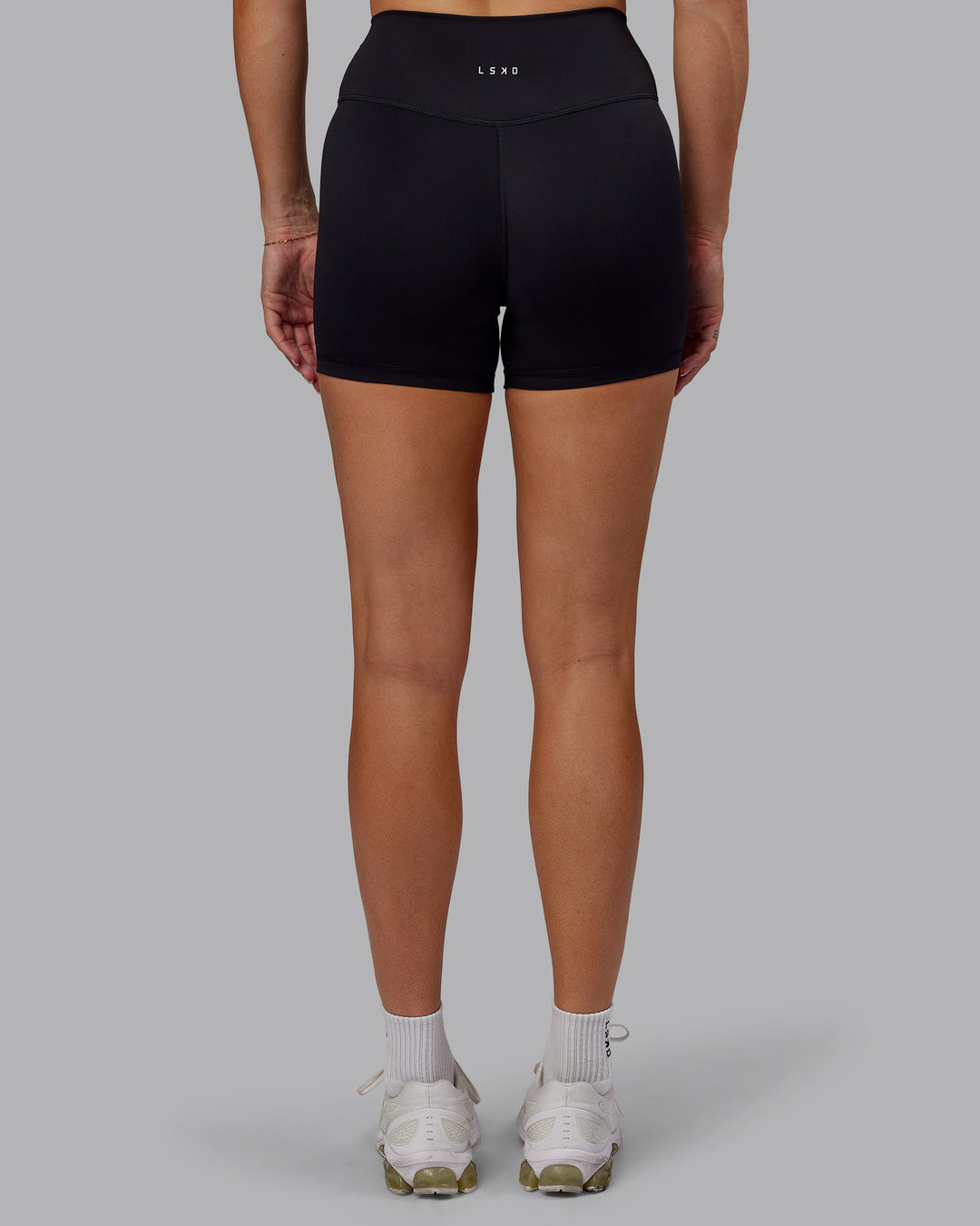 Woman wearing Fusion Ultra High-Rise 4&quot; Short - Black | Model:Hannah | Size:S