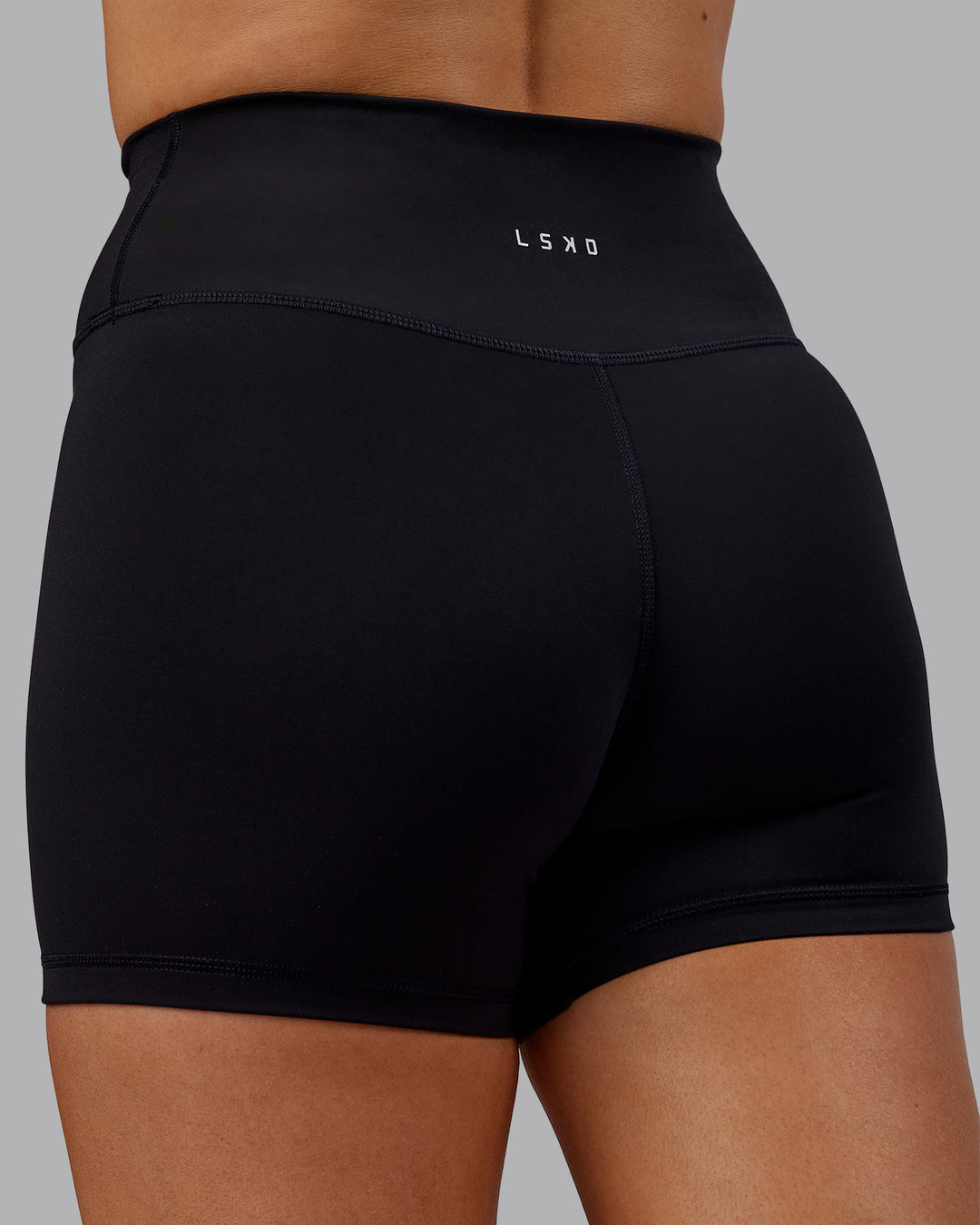 Woman wearing Fusion Ultra High-Rise 4&quot; Short - Black | Model:Hannah | Size:S