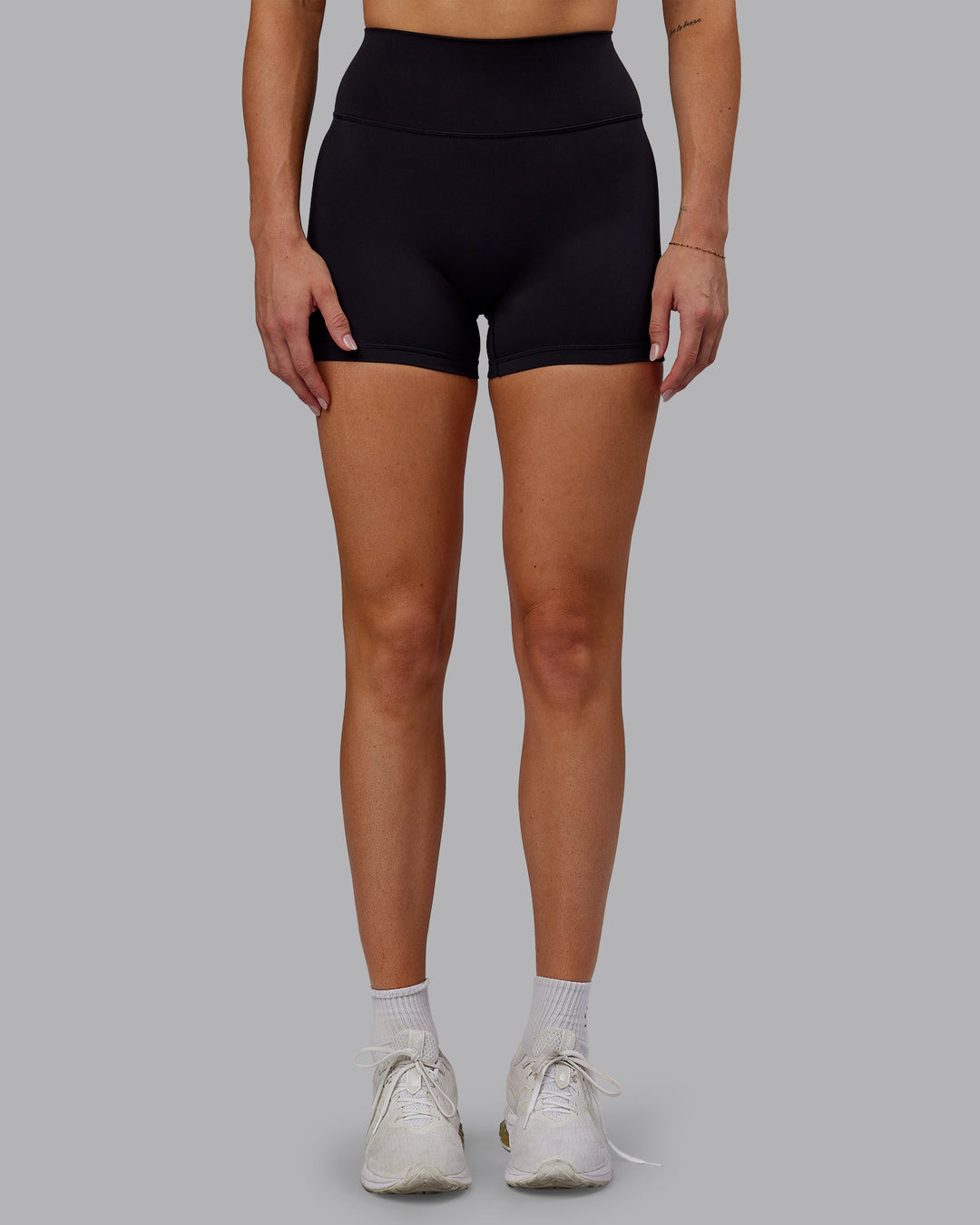 Woman wearing Fusion Ultra High-Rise 4&quot; Short - Black | Model:Hannah | Size:S