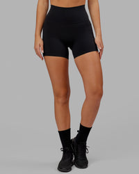 Woman wearing O.G. Fusion Ultra High-Rise 4" Short Pockets - Black | Model:Milly | Size:S