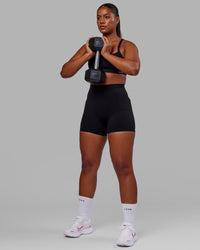 Woman wearing O.G. Fusion Ultra High-Rise 4" Short Pockets - Black | Model:Sierra | Size:L