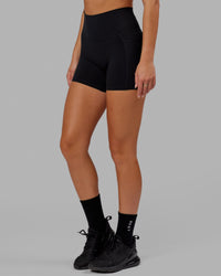 Woman wearing O.G. Fusion Ultra High-Rise 4" Short Pockets - Black | Model:Milly | Size:S
