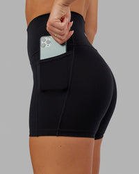 Woman wearing O.G. Fusion Ultra High-Rise 4" Short Pockets - Black | Model:Milly | Size:S