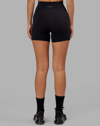 Woman wearing O.G. Fusion Ultra High-Rise 4" Short Pockets - Black | Model:Milly | Size:S
